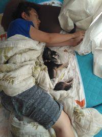 High angle view of woman sleeping on bed