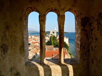 View of sea seen through arch window