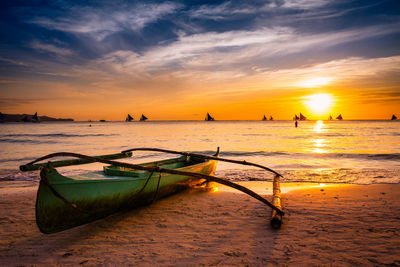 Boat on shore at sunset