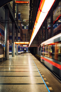 Blurred motion of train at railroad station