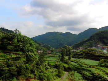 Scenic view of mountains against cloudy sky