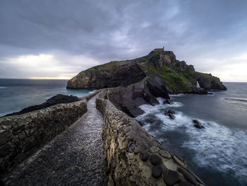 Scenic view of rocks on beach against sky