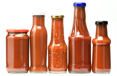 Close-up of wine bottles against white background