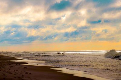 Scenic view of beach against sky during sunset