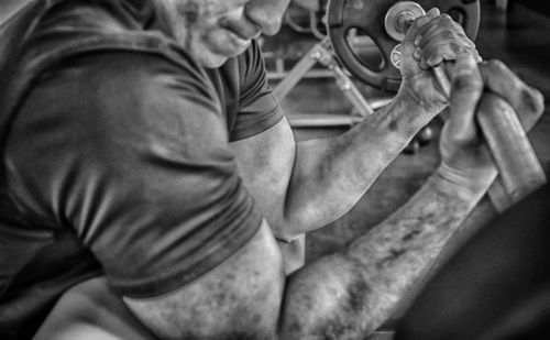 Man holding barbell curl in gym