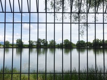 Scenic view of lake against sky seen through window