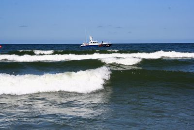 Boat sailing on sea against sky