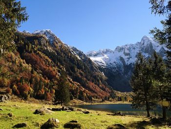 Scenic view of snowcapped mountains against clear sky