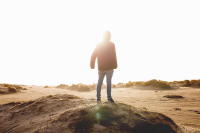 Rear view of man standing on beach