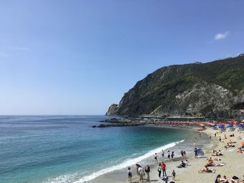 People on beach against sky