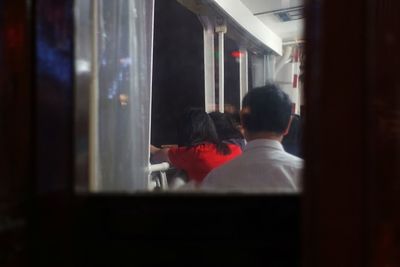 Rear view of people in train