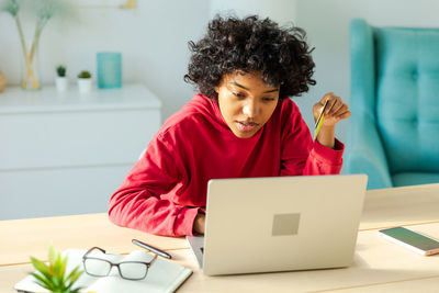 Young woman using laptop at home