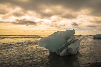 Scenic view of sea against sky during sunset whit some ice