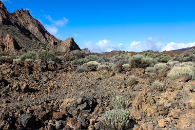 Scenic view of rocky mountains against blue sky