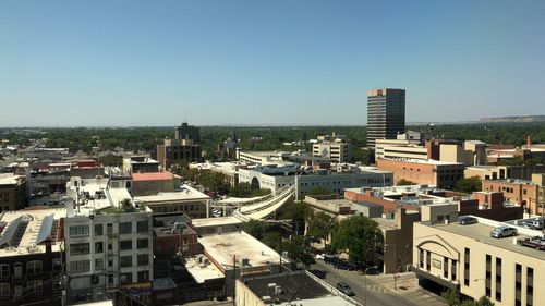 High angle view of buildings against clear blue sky