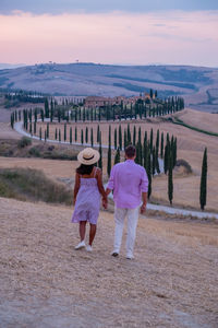 Rear view of women walking on landscape