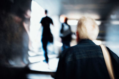 Rear view of people walking on street