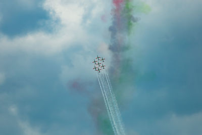 Low angle view of airplane flying against sky