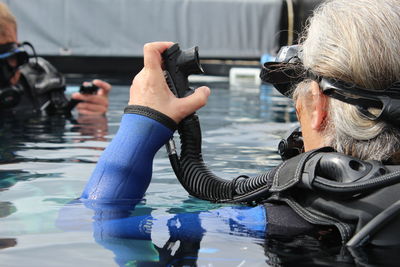 Close-up of woman learning scuba diving in swimming pool