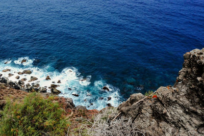 High angle view of rocks at sea shore