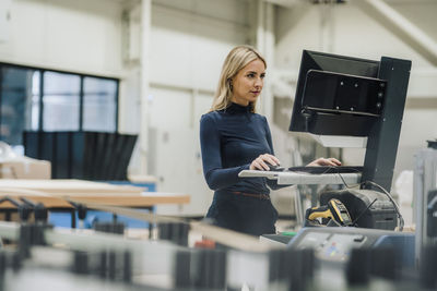 Businesswoman working on desktop pc in carpentry factory