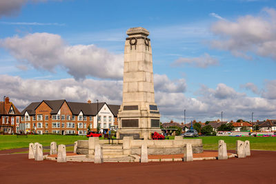 Buildings against cloudy sky