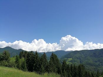 Scenic view of mountains against blue sky