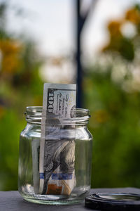 Close-up of coins in jars on table