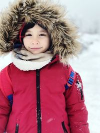 Portrait of smiling boy wearing warm clothing in winter