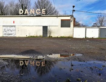 Reflection of house in puddle