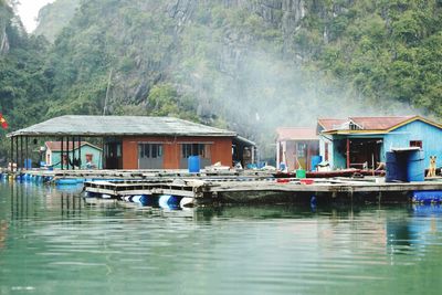 Panoramic view of lake and buildings against trees