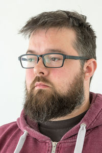 Portrait of man wearing eyeglasses against white background