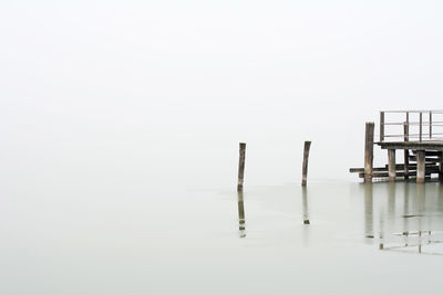 Pier and wooden posts on sea