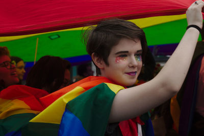 Portrait of smiling boy with multi colored flags