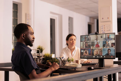 Side view of business colleagues working at restaurant