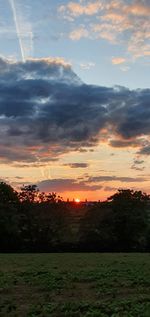 Scenic view of field against sky during sunset