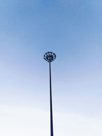 Low angle view of floodlight against blue sky