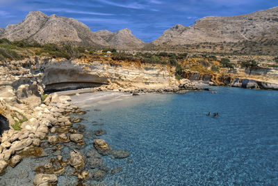 Scenic view of sea and mountains against sky