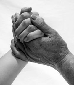 Close-up of father holding baby hand