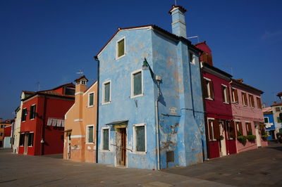 Low angle view of old building against blue sky