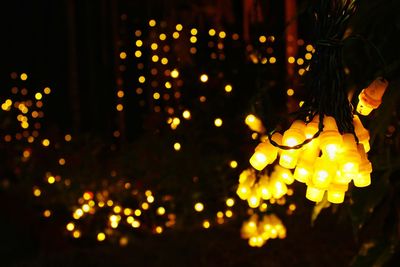 Close-up of illuminated lights at night