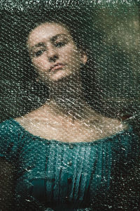 Portrait of woman seen through glass