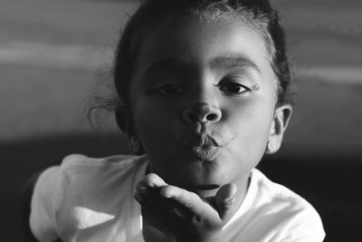 Close-up portrait of girl blowing kiss