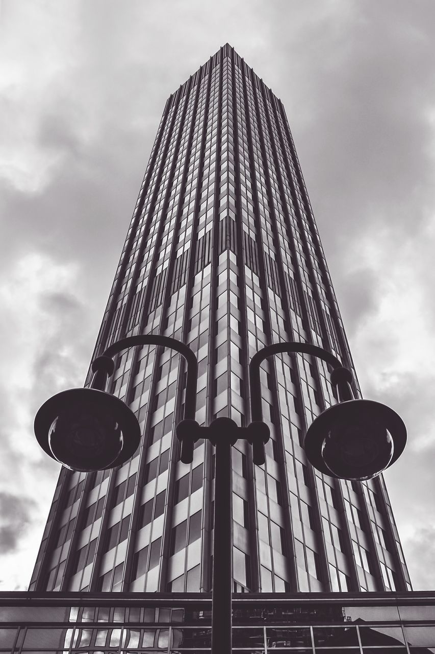 low angle view, architecture, built structure, building exterior, sky, tower, tall - high, cloud - sky, cloudy, famous place, cloud, travel destinations, city, international landmark, modern, capital cities, skyscraper, tourism, no people, outdoors