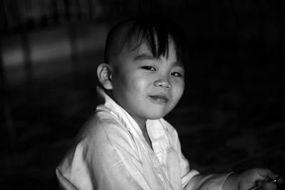 Portrait of cute boy in darkroom