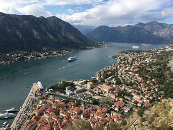 High angle view of town by sea and mountains