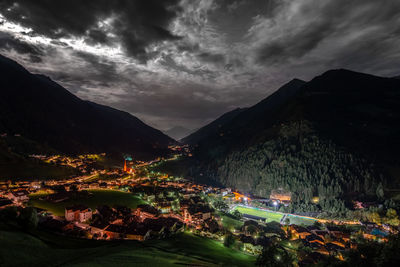 Aerial view of illuminated city against sky at night