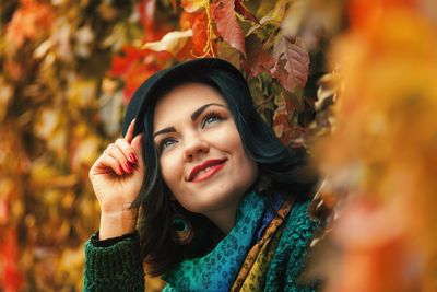 Beautiful woman amidst autumn leaves