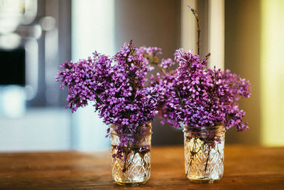 Close-up of purple flower vase on table