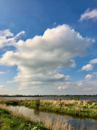 Scenic view of a cloud over river landscape